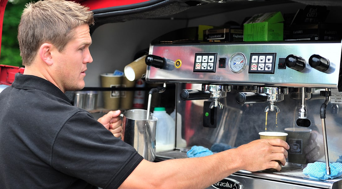 A flash-red Flying Bean Café coffee van